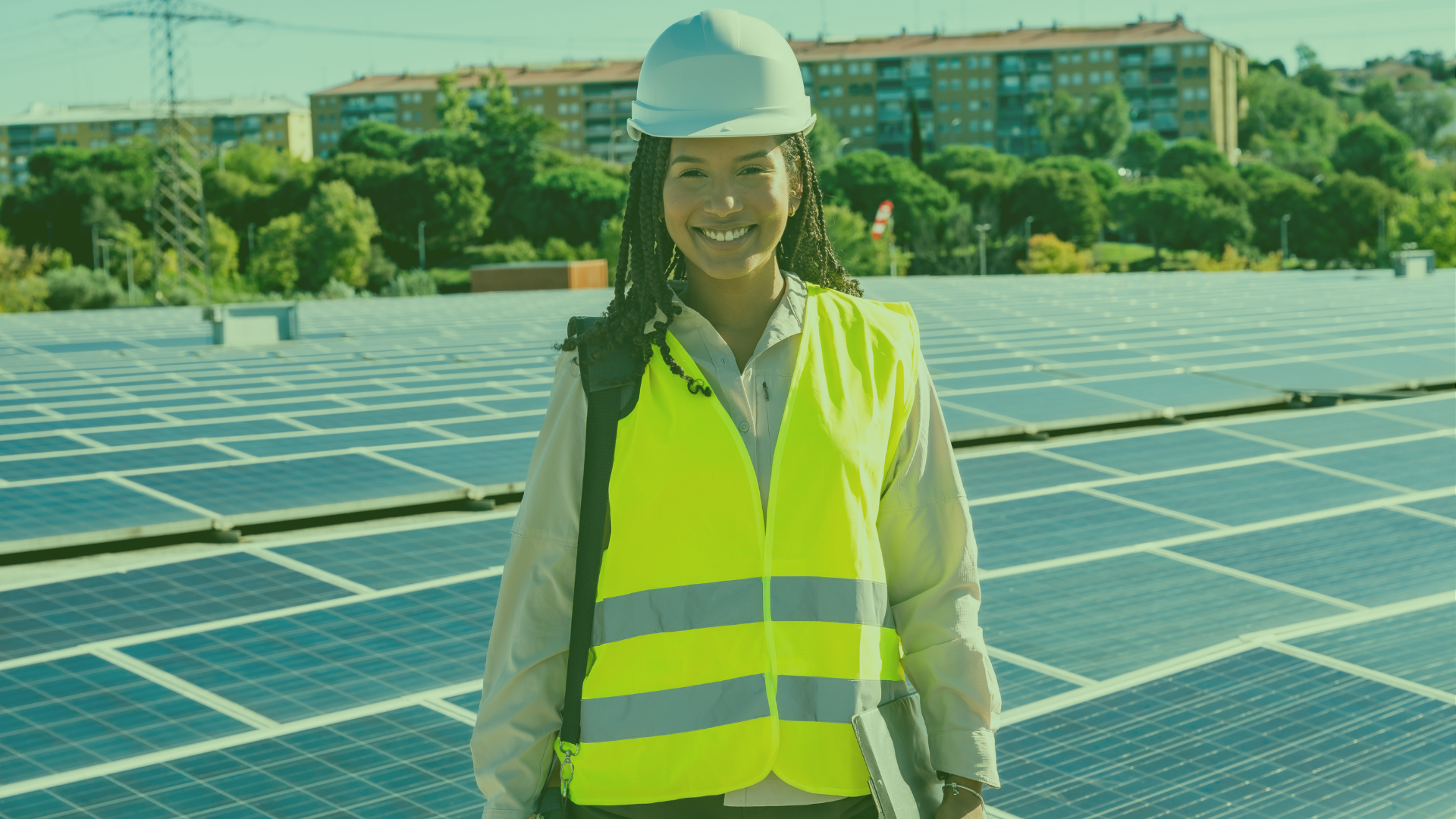 Travailleuse portant une veste jaune devant des panneaux solaires